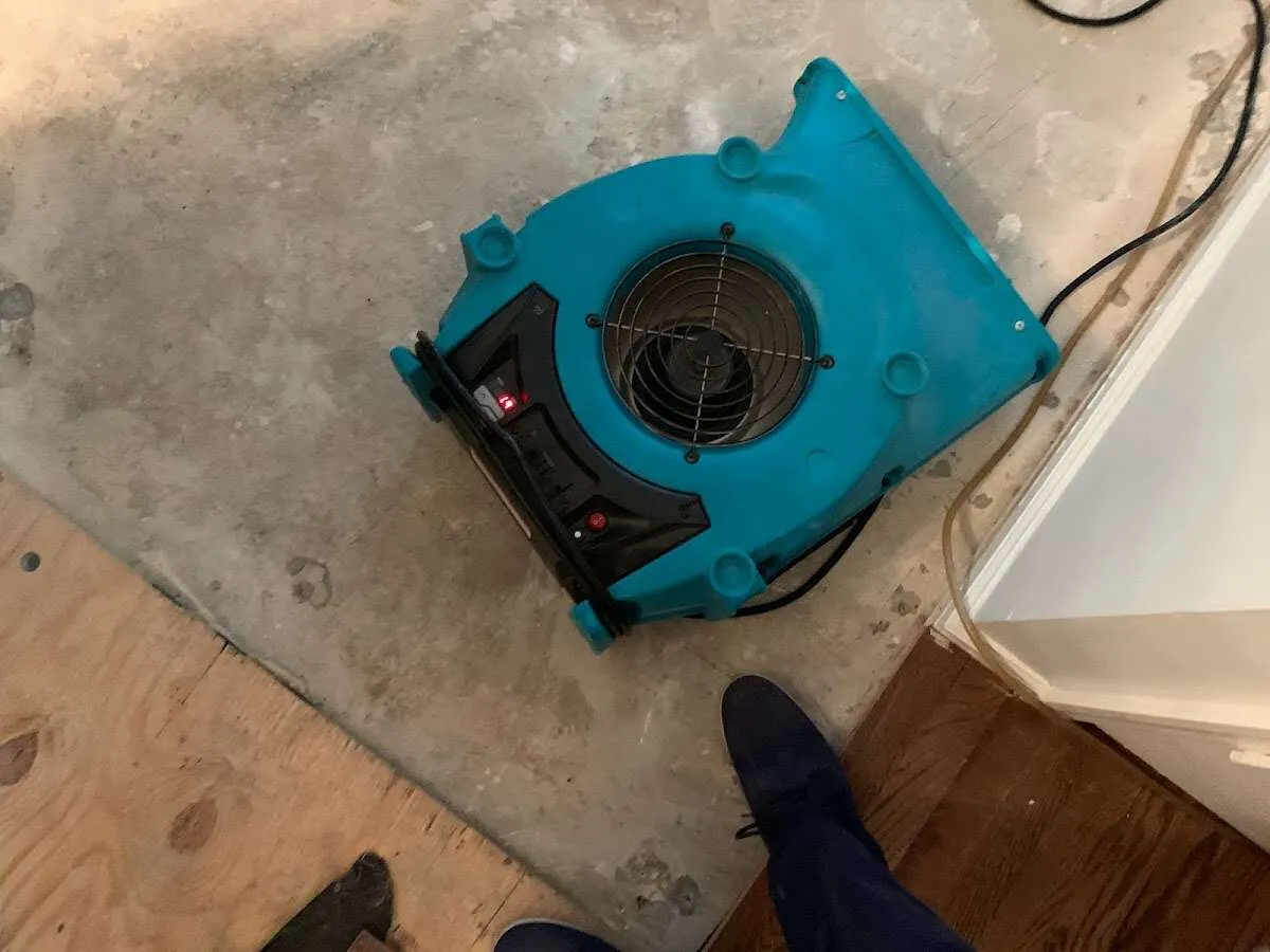 Air mover drying subfloor during Commercial Water Damage Restoration in Glenvar Heights